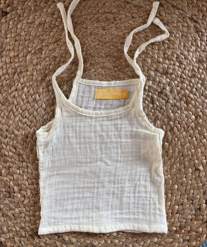 Close-up view of newborn unisex easy wear top emphasizing its minimalist design and soft muslin cotton texture.