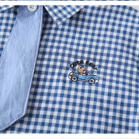 Close-up of button placket on baby boy’s checked cotton shirt with matching tie
