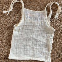 Close-up of newborn unisex easy wear top showcasing breathable muslin cotton fabric and simple design.