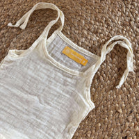 Close-up view of newborn unisex easy wear top emphasizing its minimalist design and soft muslin cotton texture.