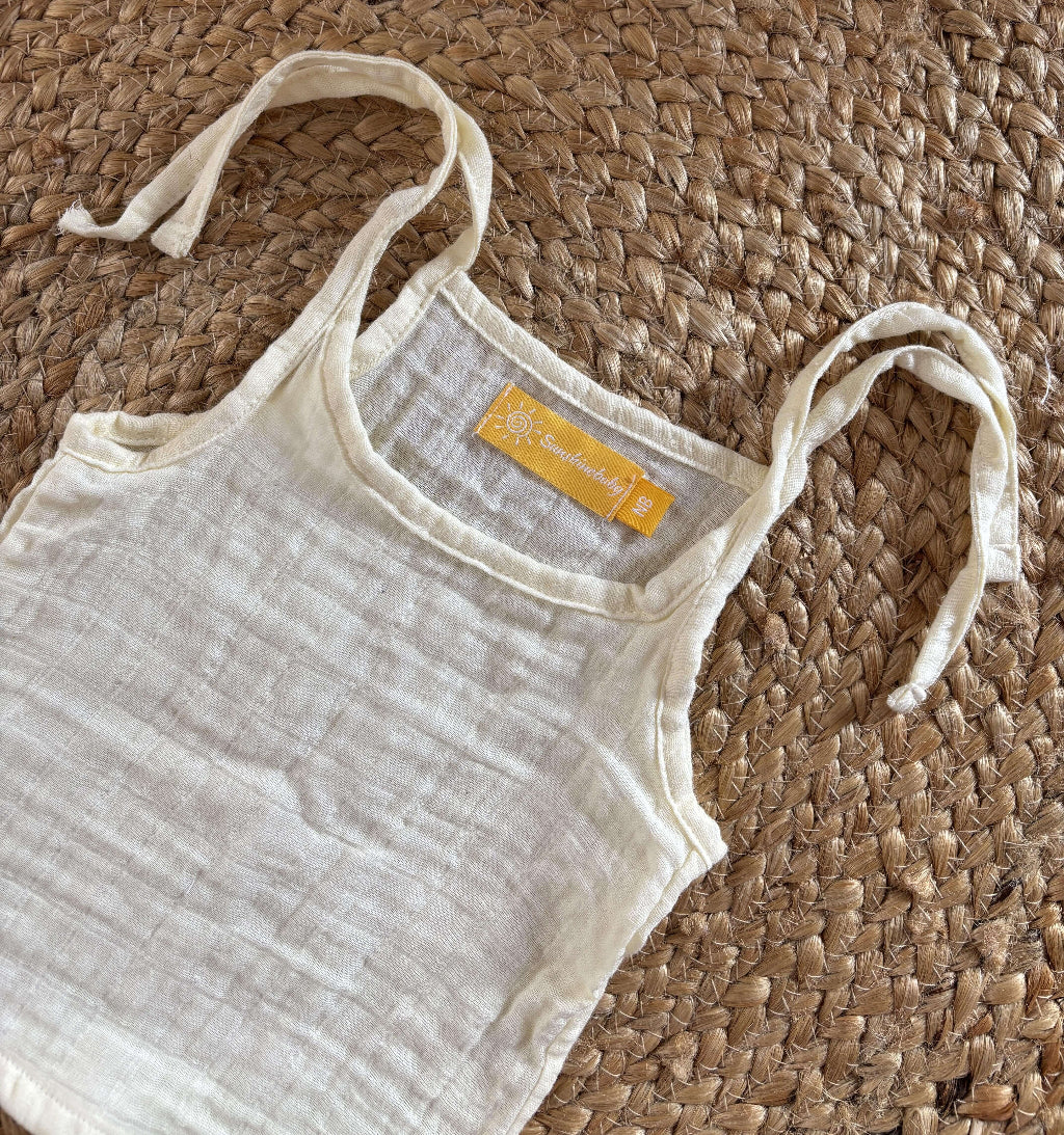 Close-up view of newborn unisex easy wear top emphasizing its minimalist design and soft muslin cotton texture.